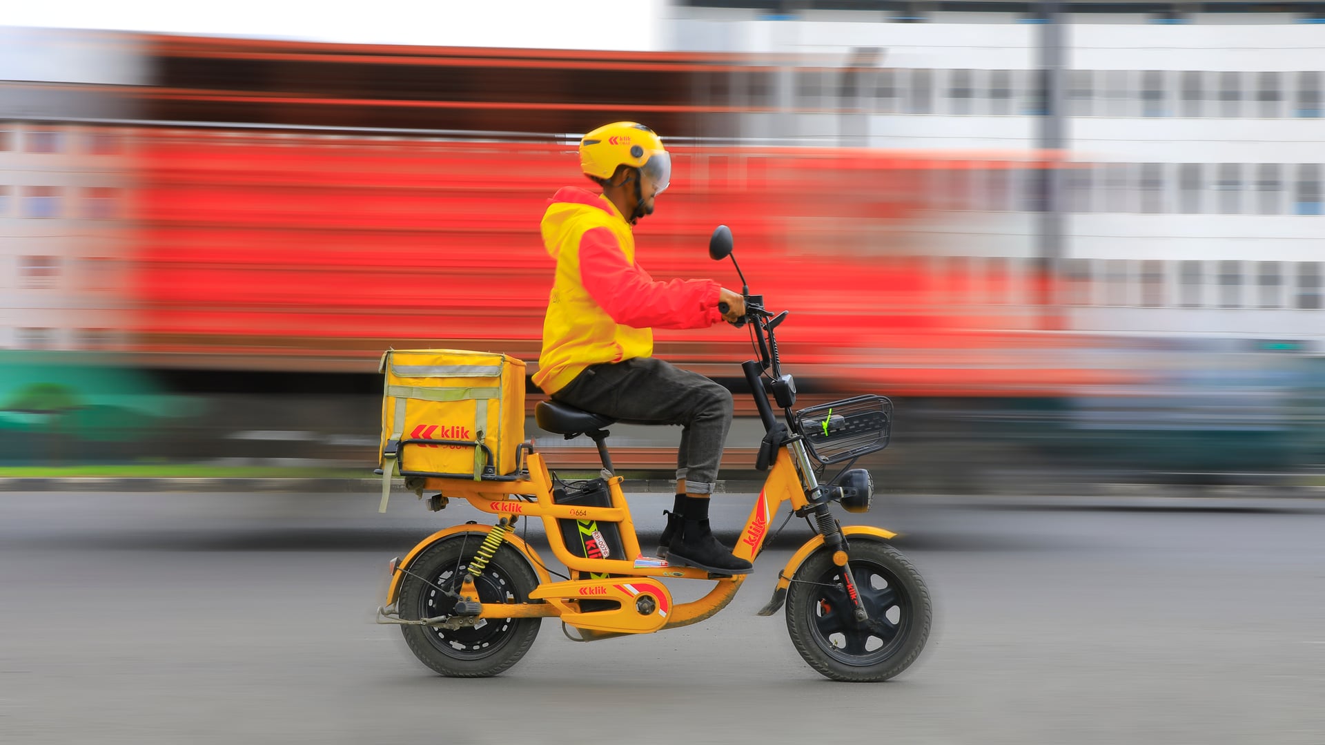klik rider next to an electric bike at a station in Addis Ababa